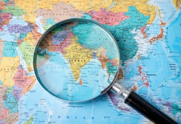 Magnifying glass focused on map of India for offshore development center