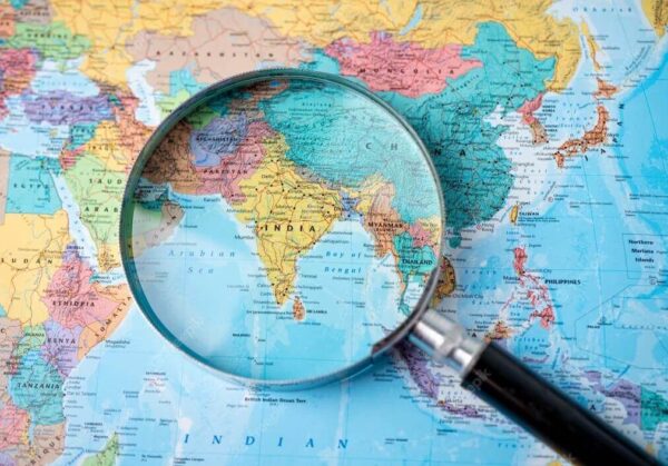 Magnifying glass focused on map of India for offshore development center
